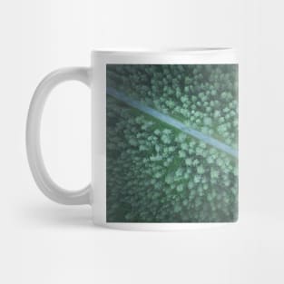 Car on the road going diagonally through the forest top down aerial view Mug